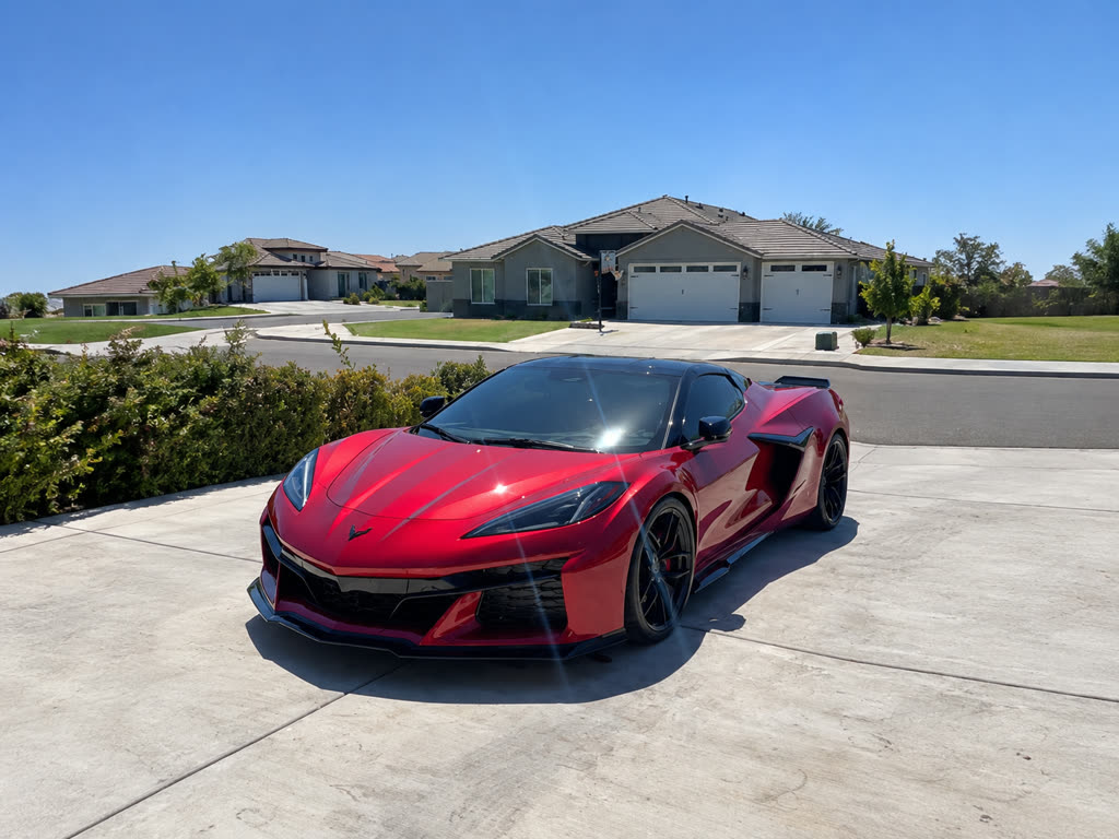 Glossy red Chevrolet Corvette C8, freshly detailed exterior gleaming in the sun